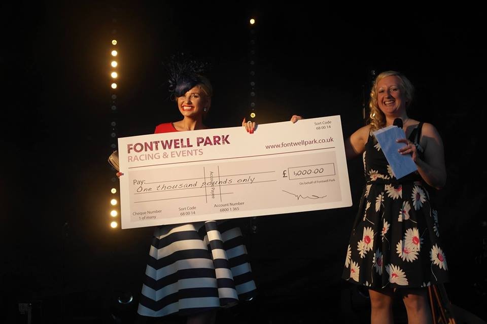 Amy hart at fontwell park collecting prize after winning best dressed competition 2016