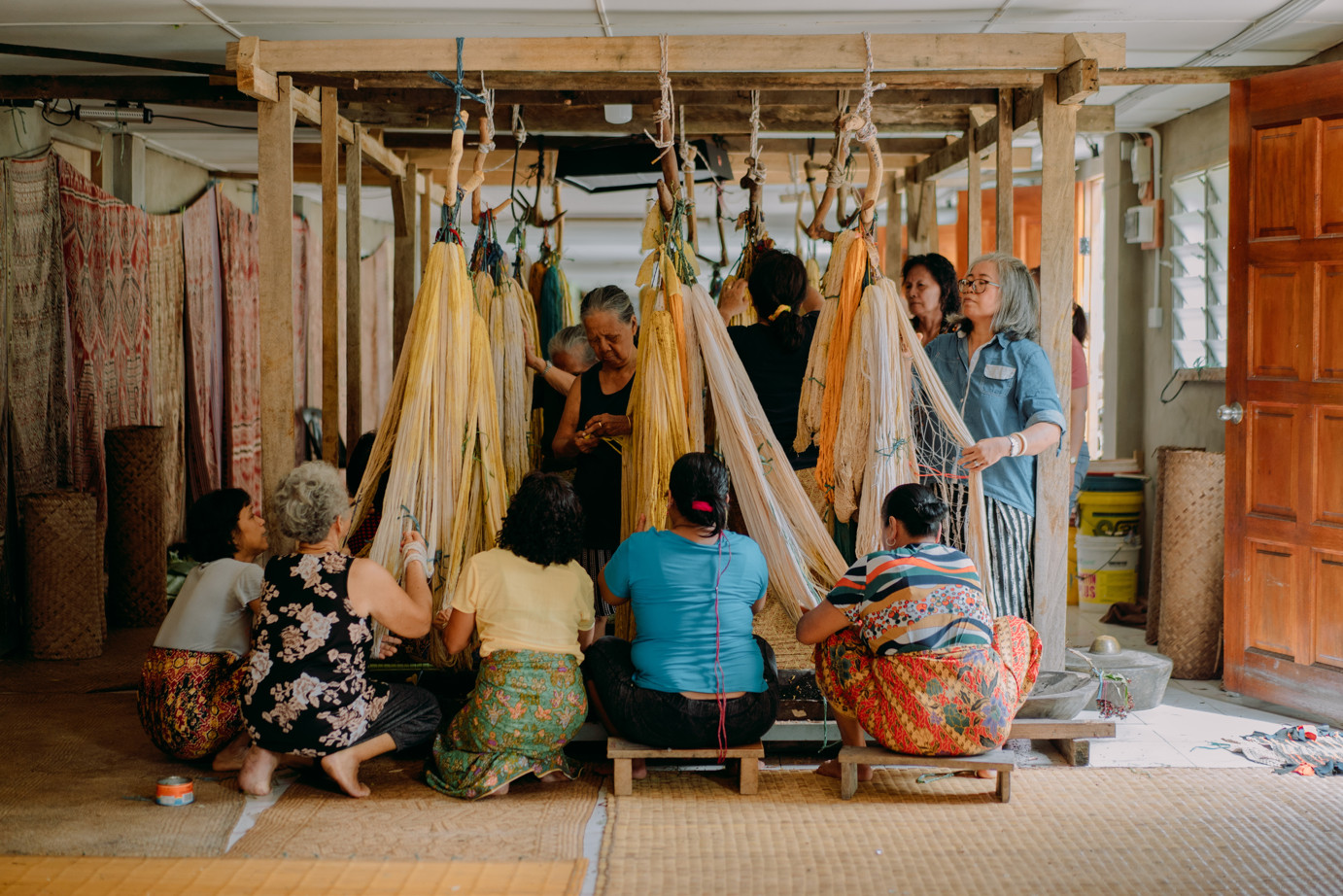 Weavers of rumah gare, preparing their threads for the ngar ritual where they mordant their threads before weaving