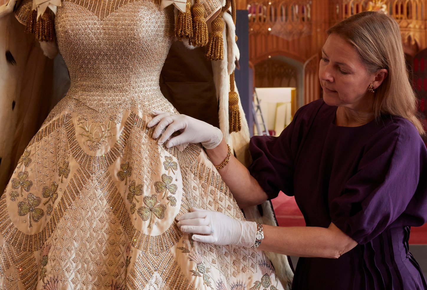 Curator caroline de guitaut puts the finishing touches to the display of her majesty the queen’s coronation dress and robe of estate in st george’s hall, windsor castlecurator caroline de (3)